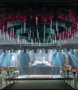 “White wedding stage decor with chandelier ceiling and floral table designs by Milano Event”