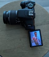 a dlsr camera on a table model name jonathan barkho