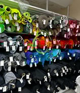 a display of many different colorful fabrics