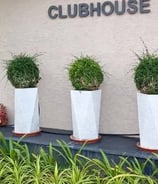 Artistic pottery accents in a heritage-inspired courtyard design by Garden Designers