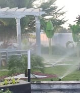 Efficient drip irrigation setup in a well-designed garden by Garden Designers