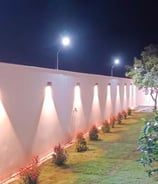 Ambient outdoor lighting creating a cozy night-time garden vibe by Garden Designers