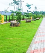 Plot development entrance with landscaped signage and driveways by Garden Designers