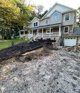a house with a pile of dirt on the ground