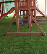 pasto sintetico con juegos infantiles