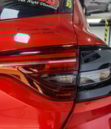 a red car with a sticker on the back of it