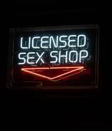 neon sign that reads licensed sex shop