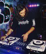 a man in a black shirt is playing a dj - Creechur
