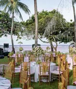 Beach wedding decoration with white drapes and tropical flowers by Pune wedding planning experts