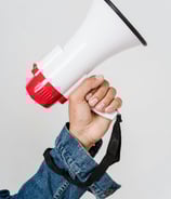 a person holding a red and white megaphone