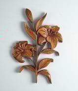 a decorative wooden carving of a lily flower