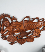 a wooden carving of a Buddha in a wooden carving of a sleeping Buddha