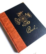 a book with a note pad and a pen