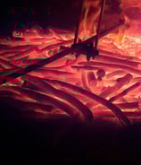 a fire pit with a fire in the background