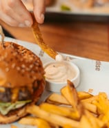 a person is holding a piece of food in front of a hamburger burger king