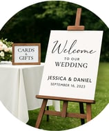 a wedding sign board with a welcome sign on it