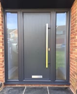 modern grey composite door with no glass.  Ral 7016 coloured frame.  2 side panels 