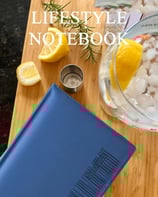 a notebook with a glass of water and lemonade