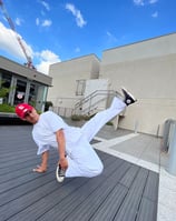 YoYo performing a breakdancing freeze.