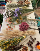 a table with a bunch of dried flowers