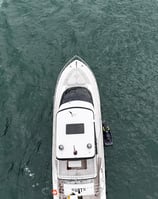 a boat with a man standing on the water