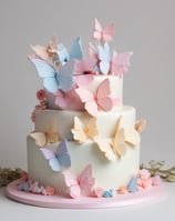 Cake with 'Wild One' topper displayed on a wooden stand. The cake features a design with green, white, and beige colors. To the right, there are two boxes with a nature-inspired pattern, and to the left, a woven basket. Green leafy decorations hang in the background.