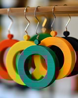 a bunch of earrings with rings on them