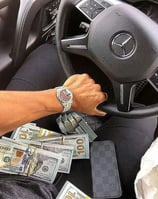 a man driving a car with money