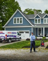 Roto-Rooter Service Technician Standing In Front of Residential Dwelling