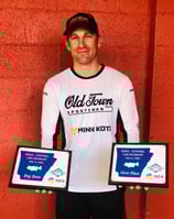 a man holding two plaques with plaques on them