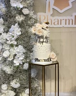 a cake with a cake topperf and flowers