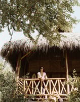 woman on her balcony overlooking the tropical garden