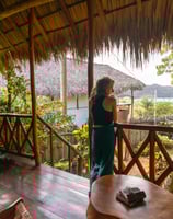 woman on her balcony overlooking the ocean