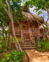 wooden bungalows in tropical garden retreat center