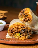 Burritos filled with ingredients, resting neatly on top of one another.