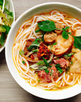 Ramen birria noodles topped with a flavorful garnishing.