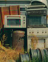 a kitchen with a stove top oven and a microwave, appliances, junk removal