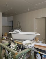 a bathtub with a tub tub and a tub, construction debris, garbage, contractor