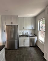 a kitchen with a refrigerator, stove, and refrigerator
