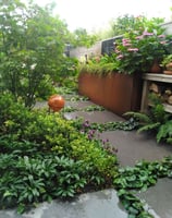 A stone path with cortensteel planter