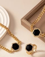a necklace and earrings set with a black and white necklace