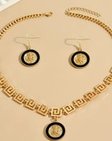 a necklace and earrings set with a gold chain link necklace