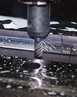 CNC Milling machine that is cutting through a piece of metal