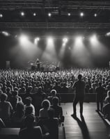 A black and white mural depicts a person with closed eyes singing passionately into a microphone. The person wears headphones and has light-colored hair. The background includes a crowd of people, suggesting a concert or performance setting. The image is artistically stylized, creating a dramatic and energetic atmosphere.