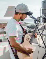 a man with a guitar and a microphone