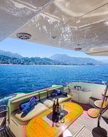 a boat with a table and chairs on the deck