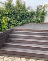 a wooden deck with a bench and a bench