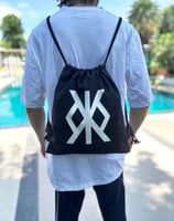 a man with a backpacker bag on his back, standing in front of a swimming pool