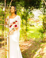 a woman in a white dress and a bouquet of flowers