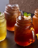 a variety of drinks in mason jars with lemonade
